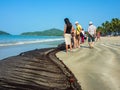 PALOLEM, GOA, INDIA Ã¢â¬â February 22, 2011: Tourists looking at a fishing net lying on the sand near the water